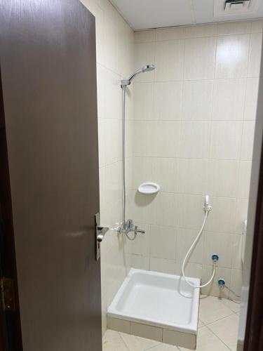 a bathroom with a shower with a sink at F30,R4,Single Room on the beach attach bath in Ajman 