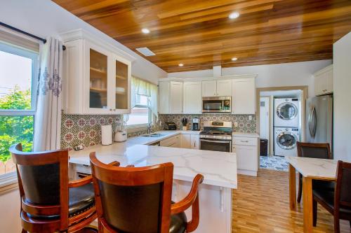 a kitchen with white cabinets and a table and chairs at Alameda luxury 2BR 2BA house, AC, near ferry to San Francisco, 2 free parking spaces in Alameda