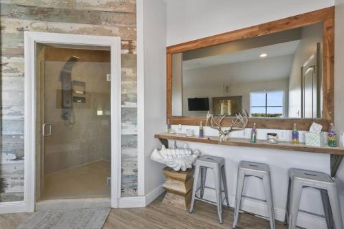 a bathroom with a vanity with a mirror and a shower at Hotel Pass Christian Penthouse in Pass Christian