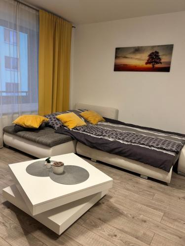 a bedroom with a large bed and a coffee table at AR RADNICA HOUSE in Košice