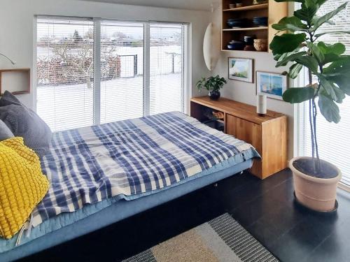 a bedroom with a bed and a large window at Holiday home Karrebæksminde XIII in Karrebæksminde