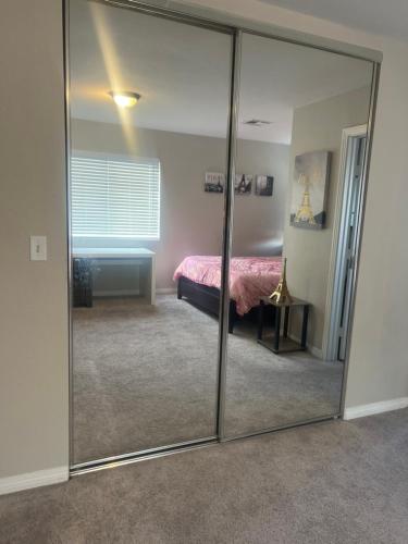 a large mirror in a bedroom with a bed at Big private room in Las Vegas