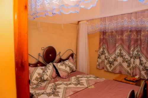 Postel nebo postele na pokoji v ubytování Rooms in Bujumbura City