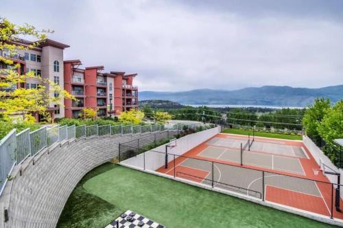 an image of a tennis court on a building at Kelowna family-friendly lake & Mountain view Luxury condo with AC, pool, Hot tub, near winery and shopping center in West Kelowna