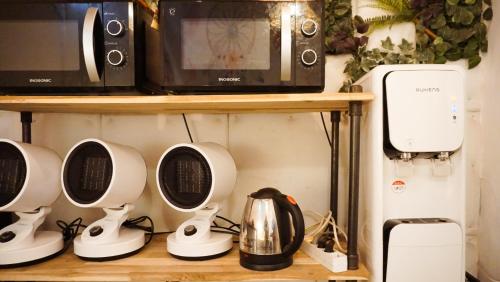 a shelf with a microwave and appliances on it at Space ARA in Seoul