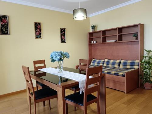 a living room with a dining table and a couch at Casa da Vila in Santa Cruz