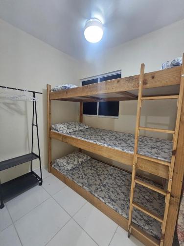a room with two bunk beds in a room at Marques Beach House in Marechal Deodoro
