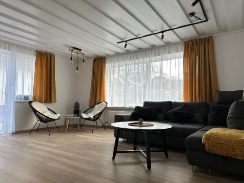 ein Wohnzimmer mit einem Sofa und einem Tisch in der Unterkunft Apart7 in Lermoos