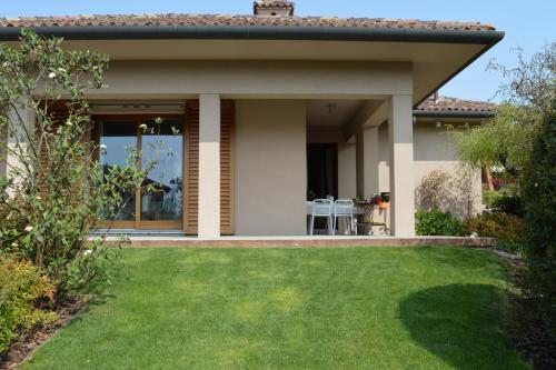 a house with a lawn in front of it at B&B La Casa di Angela in Cusago