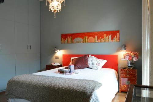 a bedroom with a bed and a chandelier at B&B La Casa di Angela in Cusago