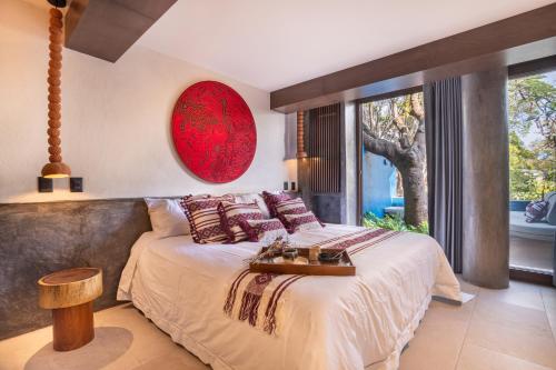 a bedroom with a large bed and a large window at Casa Cristina Fresh Boutique Hotel in Cuernavaca