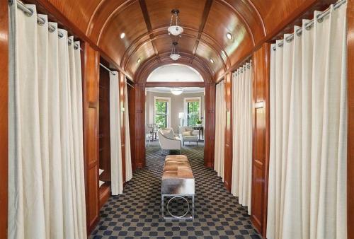 a hallway of a house with a table and curtains at Clarendon Square in Boston