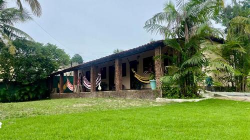 a house with two american flags in front of it at Pousada Recanto das Orquídeas in Barreirinhas