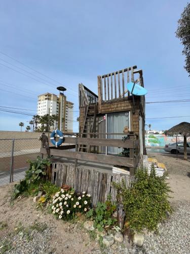 a wooden chair sitting on top of a wooden fence at Beach Bungalow in Rosarito