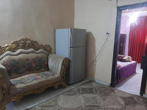 a living room with a couch and a refrigerator at Lotus Pyramids Hotel in Cairo