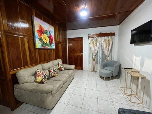 a living room with a couch and a chair at Departamento Ángeles del Arenal #2 in Fortuna