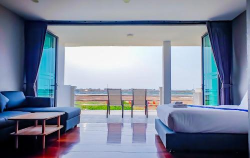 a living room with a bed and a couch and a table at The Riva Vientiane Hotel in Vientiane