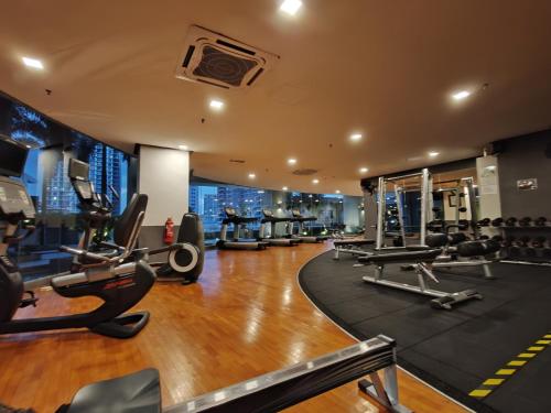 a gym with treadmills and cardio equipment in a building at No Other Fee #Swiss Garden Residences by The Boston House #Bukit Bintang in Kuala Lumpur