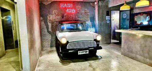 an old car is parked in a room at Hash Silom Apartment @ Silom Soi 3 in Bangkok
