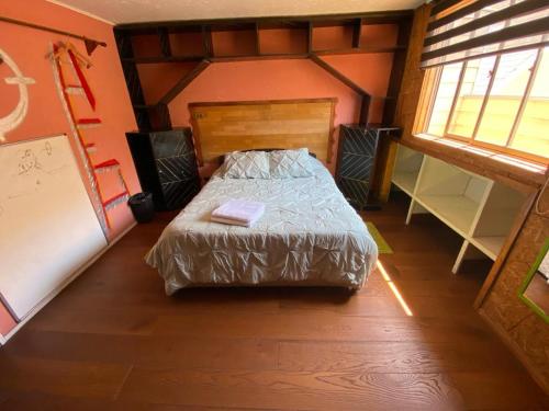 a bedroom with a bed in a small room at Hostel Enea Homes in Santiago