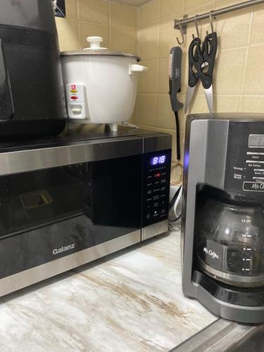 a kitchen with a microwave and a mixer on top of it at Wonderful Gables bedroom in Miami