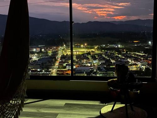 a view of a city from a window at night at Alojamiento/Lodging:El Indio Ese in Sopo