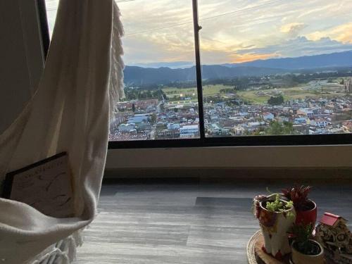 a room with a view of a city from a window at Alojamiento/Lodging:El Indio Ese in Sopo