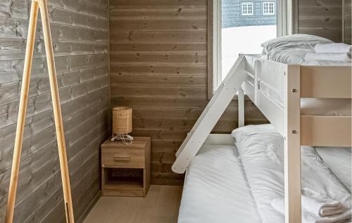 a bunk bed in a room with wooden walls at 2 Bedroom Nice Apartment In Geilo in Geilo