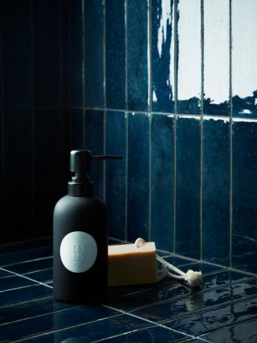 a bottle of soap and a brush on a bathroom counter at CoHouse New Haven steps to Yale University in New Haven