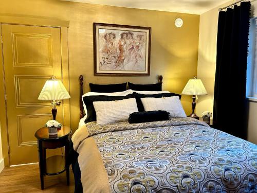 a bedroom with a large bed with two lamps at Seagull Studio Vacation Suite in Sooke