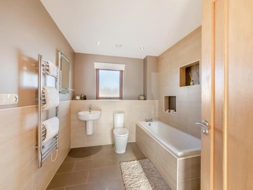 a bathroom with a sink and a toilet and a tub at The Beaches in Berwick-Upon-Tweed