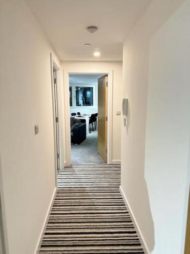 a hallway leading to a room with a living room at Stylish Central Escape, Heart of the Action, City View, Netflix in Sheffield