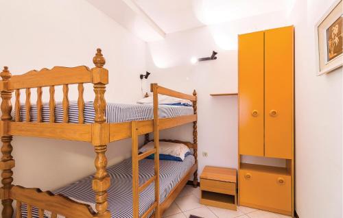 a bedroom with two bunk beds and a yellow cabinet at 2 Bedroom Stunning Apartment In Vodnjan in Vodnjan