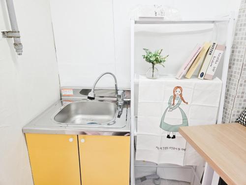 a small kitchen with a sink and a sink at 8 Hotel in Seoul