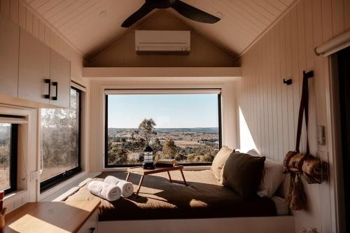 a living room with a couch and a large window at Tiny Charlie in Haden