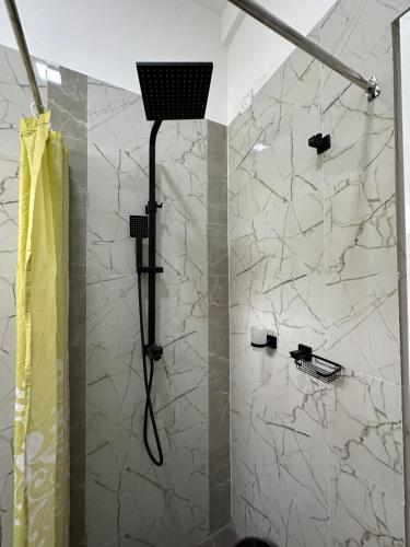 a shower with a shower head in a bathroom at Matheera holiday home in Jaffna