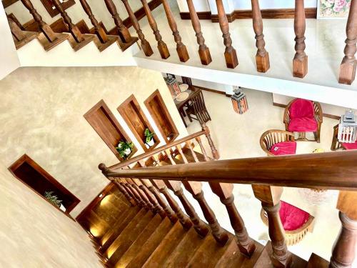 an overhead view of a spiral staircase with red chairs at Matheera holiday home in Jaffna