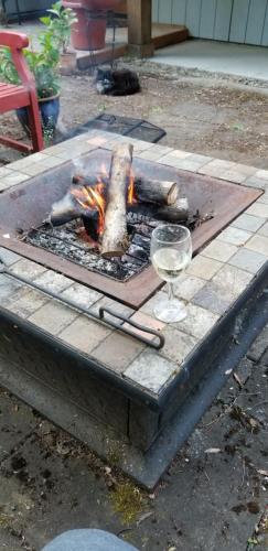 a fire pit with a glass of wine on a table at Creekside Bed and Breakfast Guest Room in Deerhorn