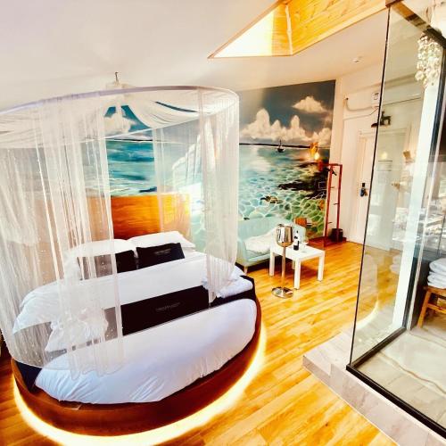 a bedroom with a bed with a painting of the ocean at Nomado Boutique Hotel in Ulaanbaatar