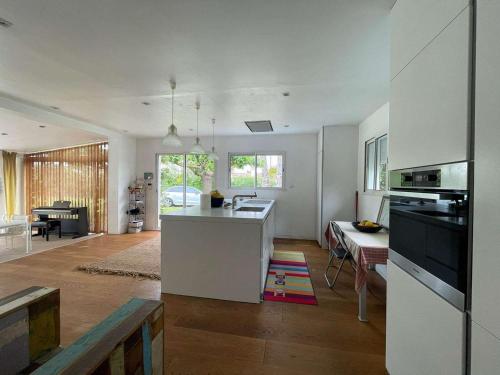 Il comprend une cuisine et un salon avec un évier et un comptoir. dans l'établissement Villa lumineuse pieds dans l'eau, accès plage direct, clim, jardin, Free WIFI, park, idéale famille! - FR-1-423-295, au Grau-dʼAgde