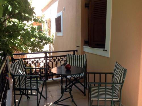 a table and four chairs on a balcony at Fenareti Apartments in Skala Eresou