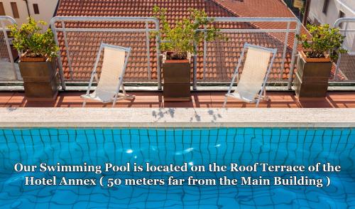 a swimming pool is located on the roof of a building at Hotel Da Vinci in Montecatini Terme