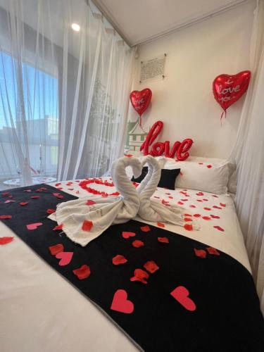 a bedroom with a bed with hearts on it at Nomado Boutique Hotel in Ulaanbaatar