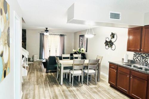 a kitchen and dining room with a table and chairs at Mandarin Cheerful 2 Bedroom Townhouse w/fireplace in Jacksonville