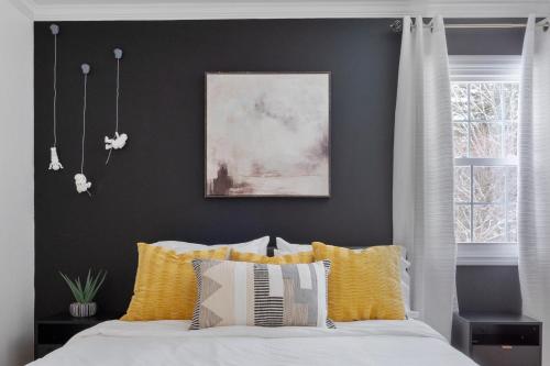 a bedroom with a bed with yellow and white pillows at Game Room+Hot Tub+Pool+King Beds+More in Gansevoort