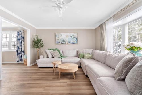 a living room with a couch and a table at Game Room+Hot Tub+Pool+King Beds+More in Gansevoort