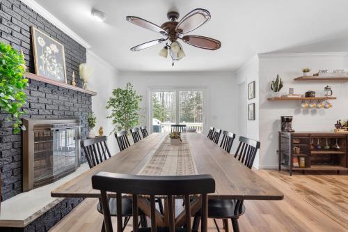 a dining room with a wooden table and a ceiling fan at Game Room+Hot Tub+Pool+King Beds+More in Gansevoort