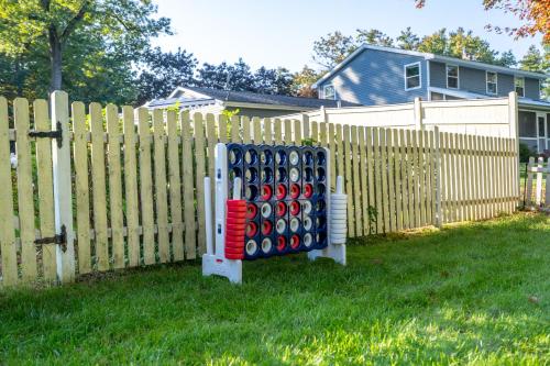 a fence with a giant stack of baseball bats at Game Room+Hot Tub+Pool+King Beds+More in Gansevoort
