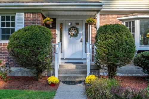 a brick house with a white door and two bushes at Game Room+Hot Tub+Pool+King Beds+More in Gansevoort