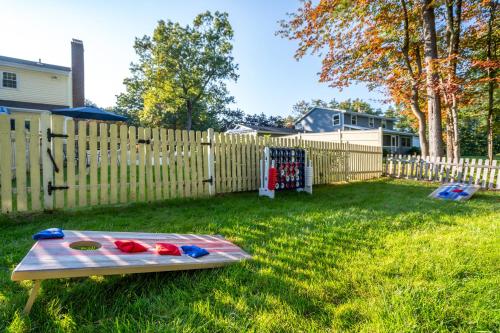 a picnic table in a yard next to a fence at Game Room+Hot Tub+Pool+King Beds+More in Gansevoort